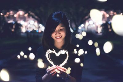 woman holding a heart of light